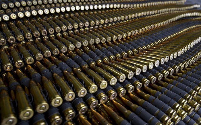 Rows of ammunition belts with brass cartridges