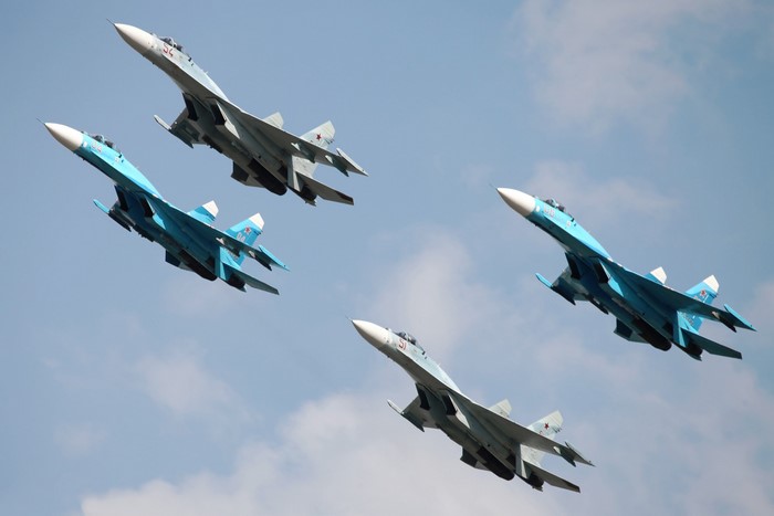 Four Sukhoi Su-27 fighter jets flying in formation