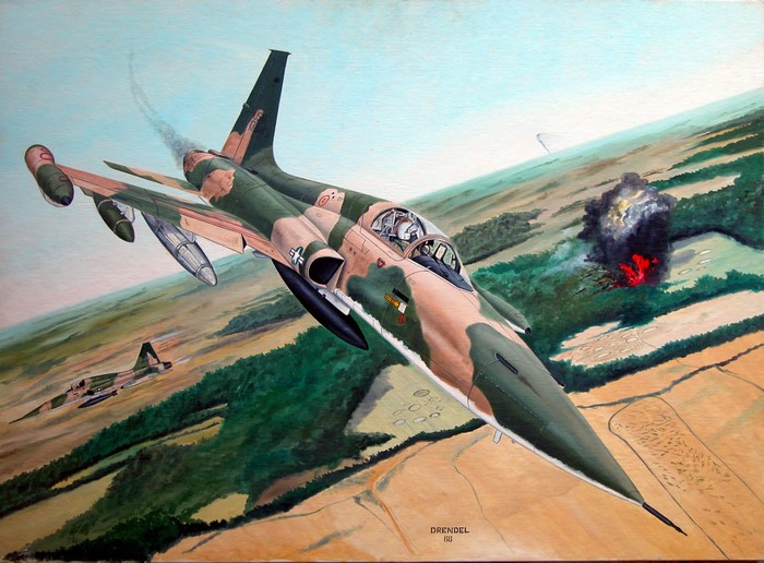 F-5 fighter jets in combat over a landscape