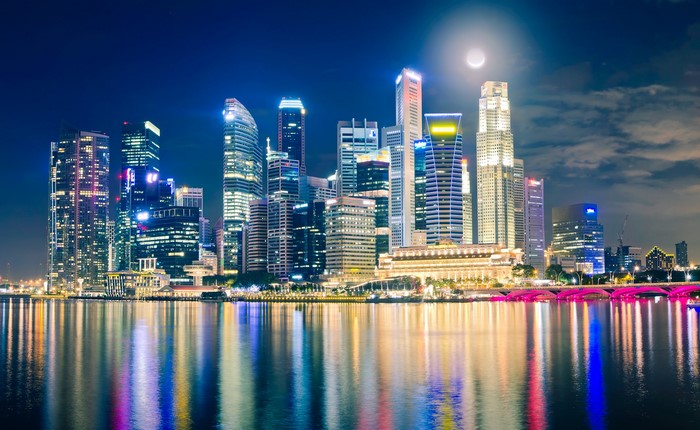 Singapore skyline at night with moon reflection