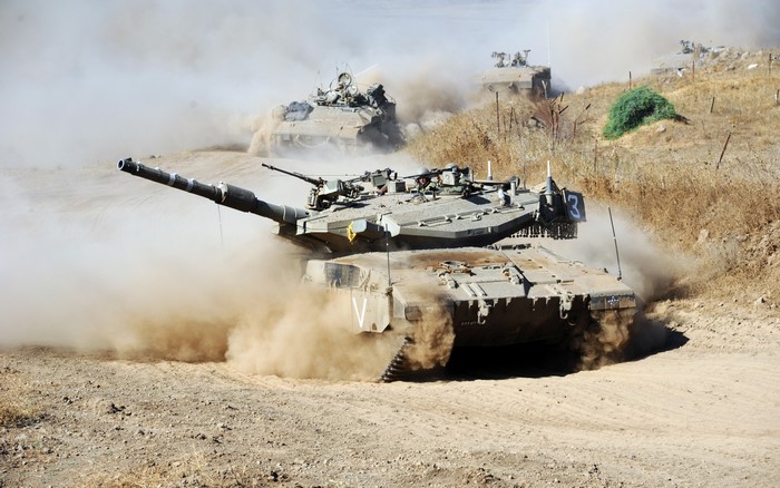 Tanks driving through dust