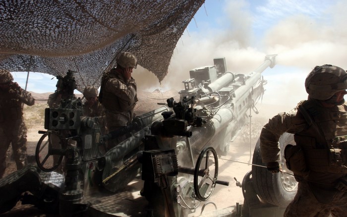 Marines firing a large artillery cannon