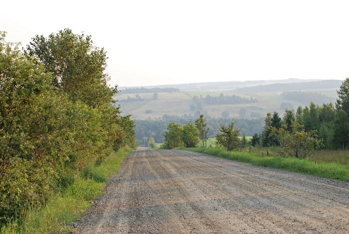 Gravel road through rolling hills in Canada