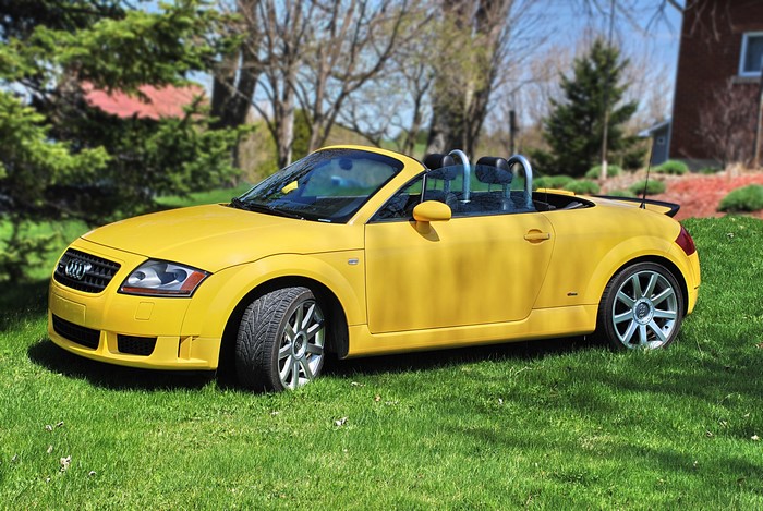 Yellow Audi TT Convertible parked on grass