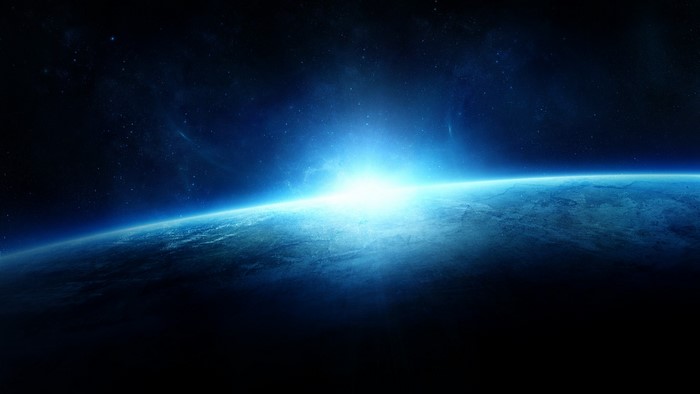 Sunrise over planet surface from space