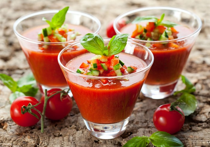 Gazpacho soup in glasses with tomatoes and basil