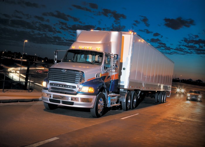 Sterling Trucks tractor-trailer on a highway at night