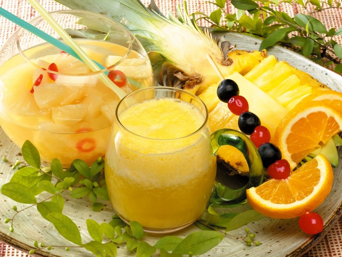 Pineapple and orange juice with fruit garnish
