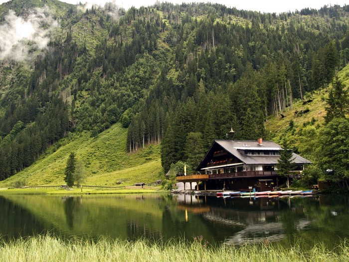 Mountain lake with a lodge and boats