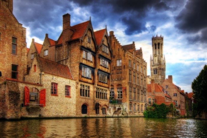 Bruges canal with historic buildings and Belfry tower