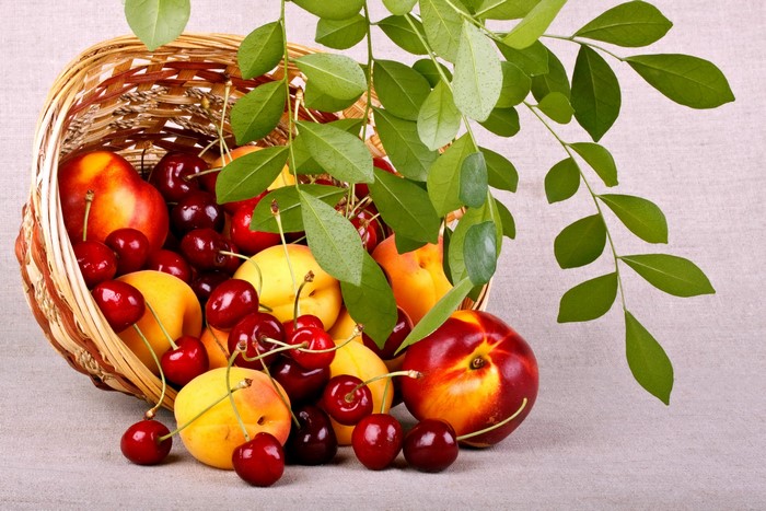 Basket of fresh fruit with leaves