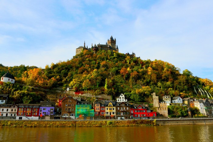 Cochem Castle and colorful houses on a riverbank in Germany