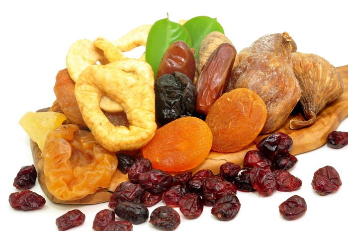 Assortment of dried fruits on a wooden board