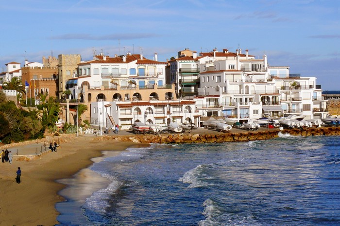 Coastal town with white buildings and boats in Spain