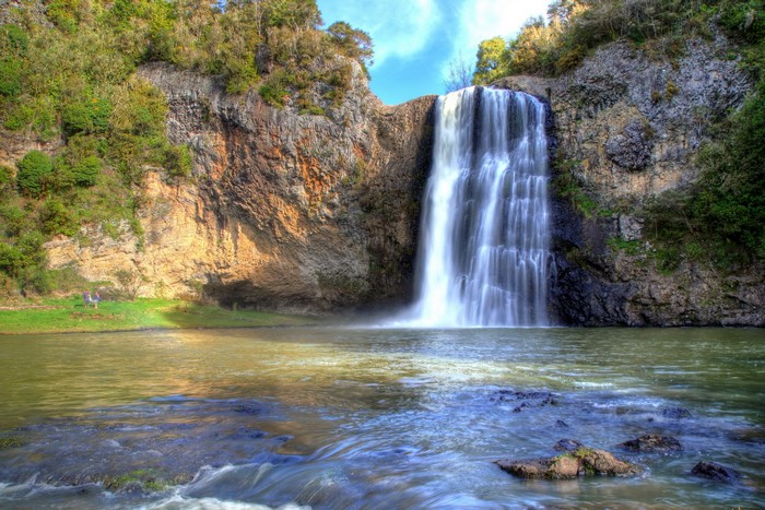 Waterfall cascading over rocky cliffs into a pool