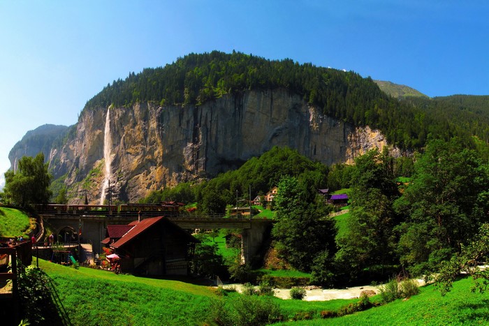 Waterfall and train bridge in a Swiss mountain village