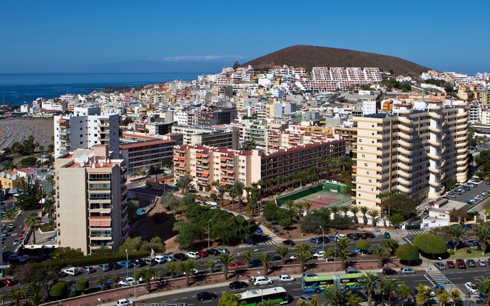 Coastal city with buildings and a hill in Spain