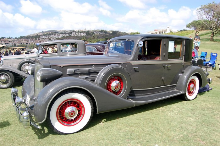 Vintage gray Packard sedan on a grassy field