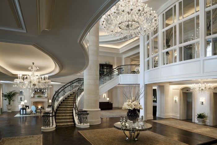 Luxury hotel lobby with grand staircase and chandeliers