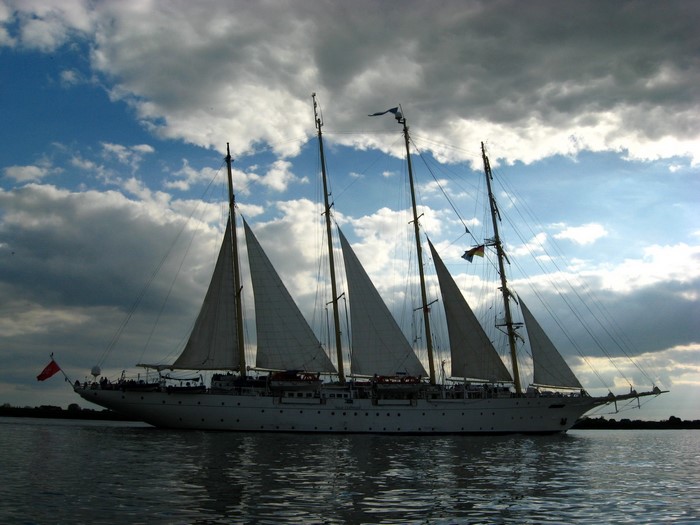 Large sailing ship with multiple sails on the water