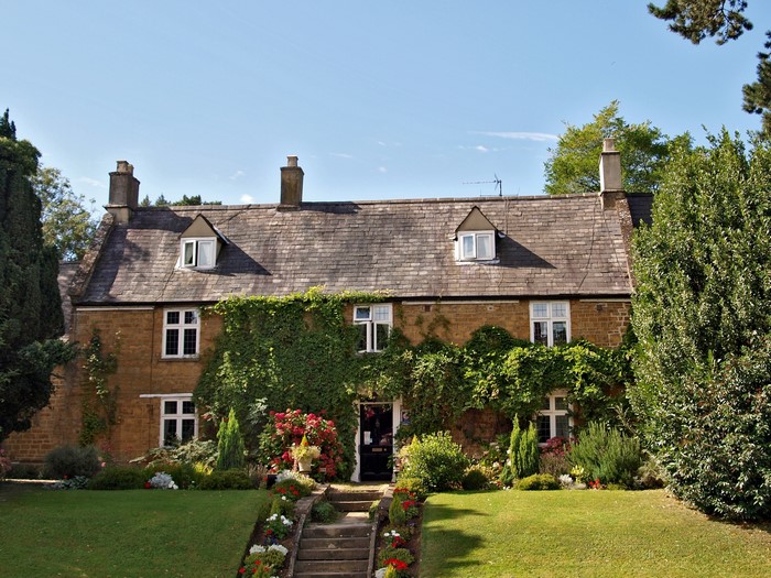 Stone house with ivy and garden in the UK