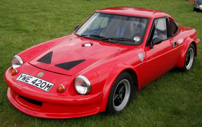 Red Ginetta G15 sports car on grass