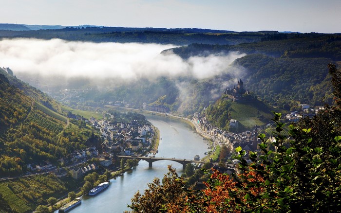 Castle on a hill overlooking a river and town in Germany