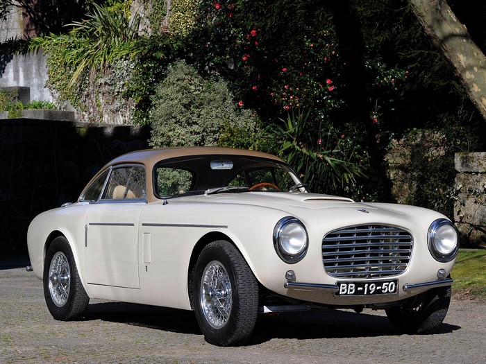 Cream-colored classic coupe car with a tan roof