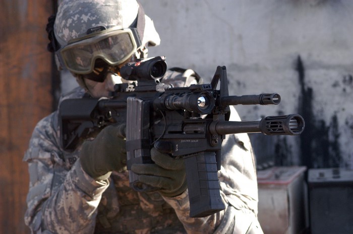 Soldier aiming assault rifle with scope