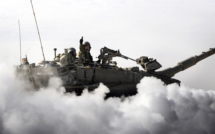 Two soldiers on a tank in smoke