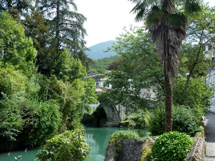 Stone bridge over a river surrounded by trees