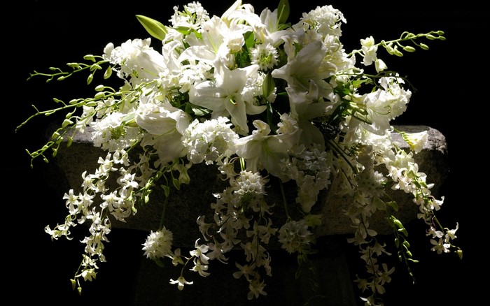 White flower bouquet on a stone pedestal