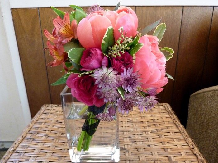 Pink and coral peony bouquet in a glass vase