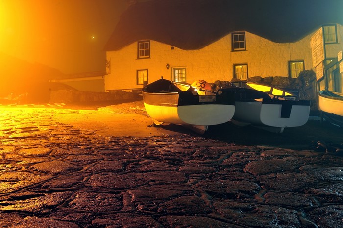 Boats on a cobblestone street at night