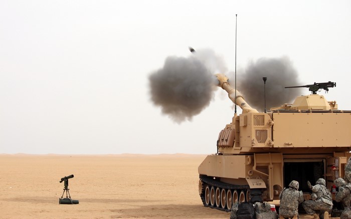 Self-propelled howitzer firing in a desert