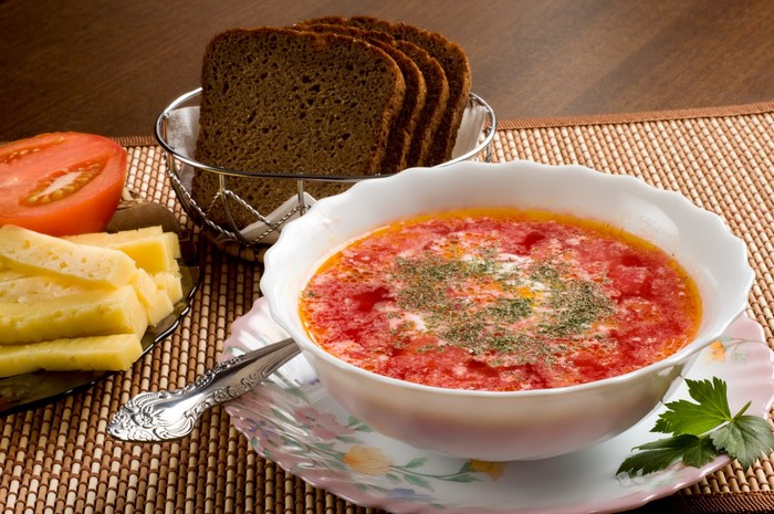Borscht soup with bread, cheese, and tomato