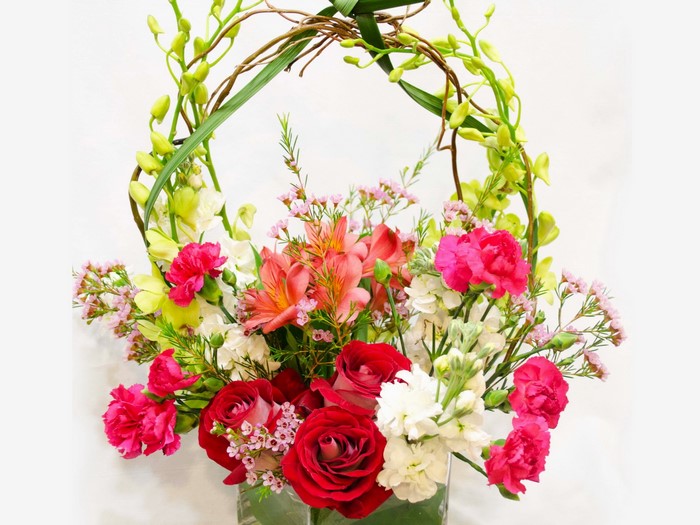 Floral arrangement with roses and orchids