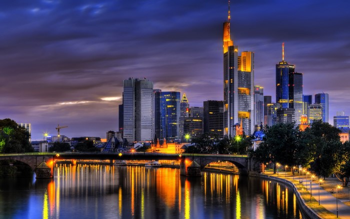 Frankfurt skyline with river and bridge at dusk