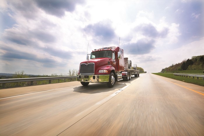 Red Mack Truck driving on a highway