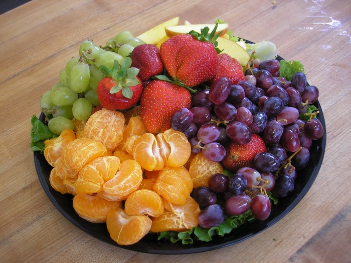 Fruit platter with grapes, strawberries, and tangerines