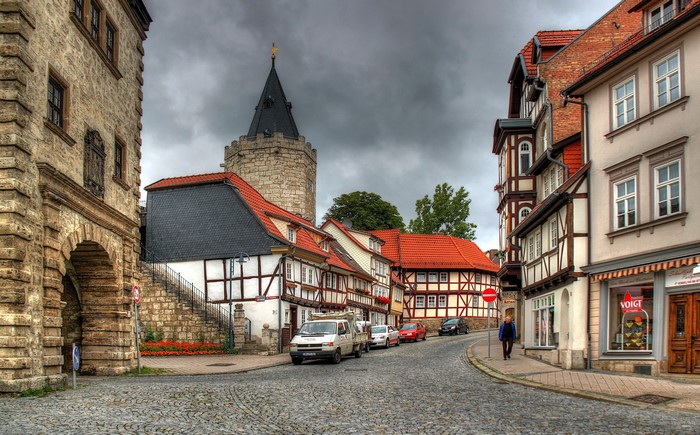 Cobblestone street with historic buildings and tower in Germany