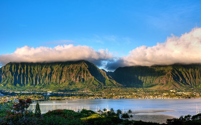 Mountains over a bay with boats and a town