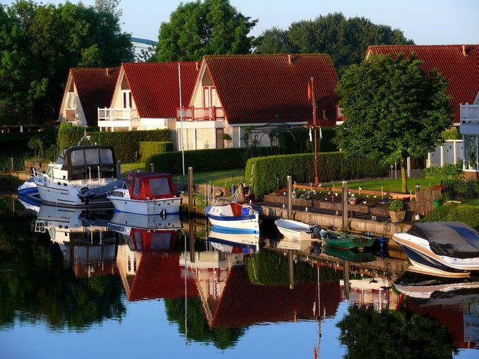 Boats docked by houses in Zwartsluis, Netherlands