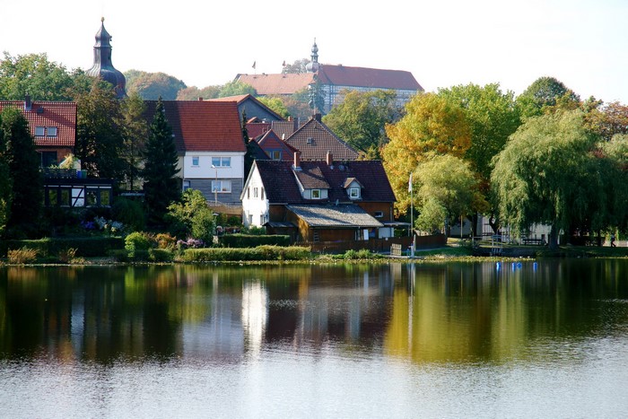 Houses and trees reflected in a lake in Germany