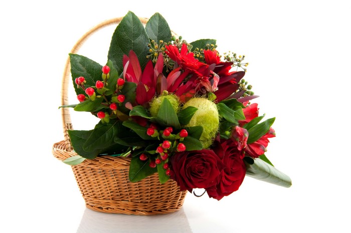 Red and green floral arrangement in a basket