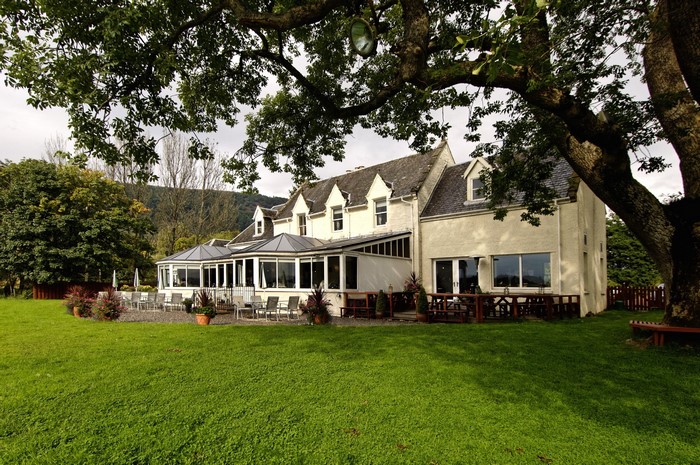 House in Scotland with garden and trees