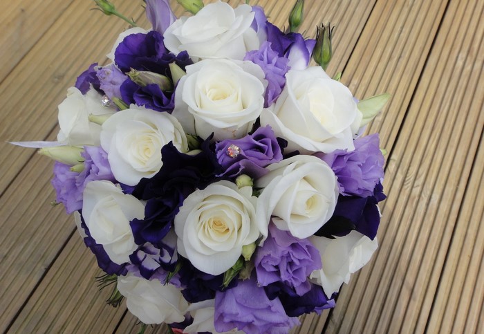 White and purple rose bouquet on wooden deck