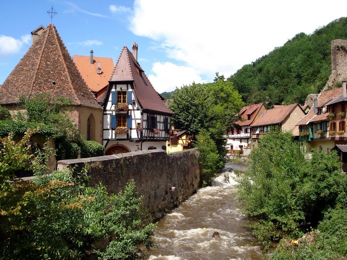 Alsace village with river and traditional houses