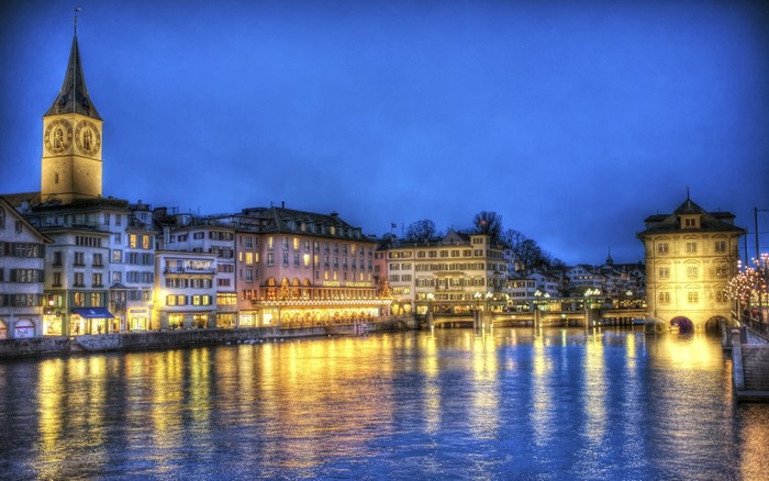 Zurich cityscape at night with river reflections
