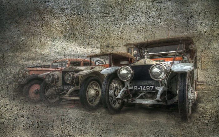 Three vintage Rolls-Royce cars parked in a row